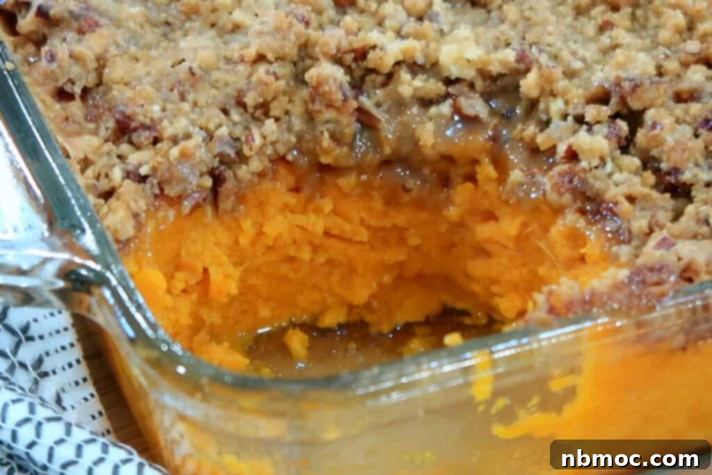 Spiced Pecan Sweet Potato Bake 3 A beautiful baking dish filled to the brim with golden brown sweet potato casserole, topped with a generous layer of crunchy pecans.