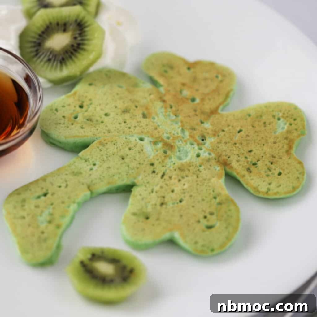 Detailed view of how to make the best shamrock pancakes, showcasing the piping technique for a perfect green pancake recipe.