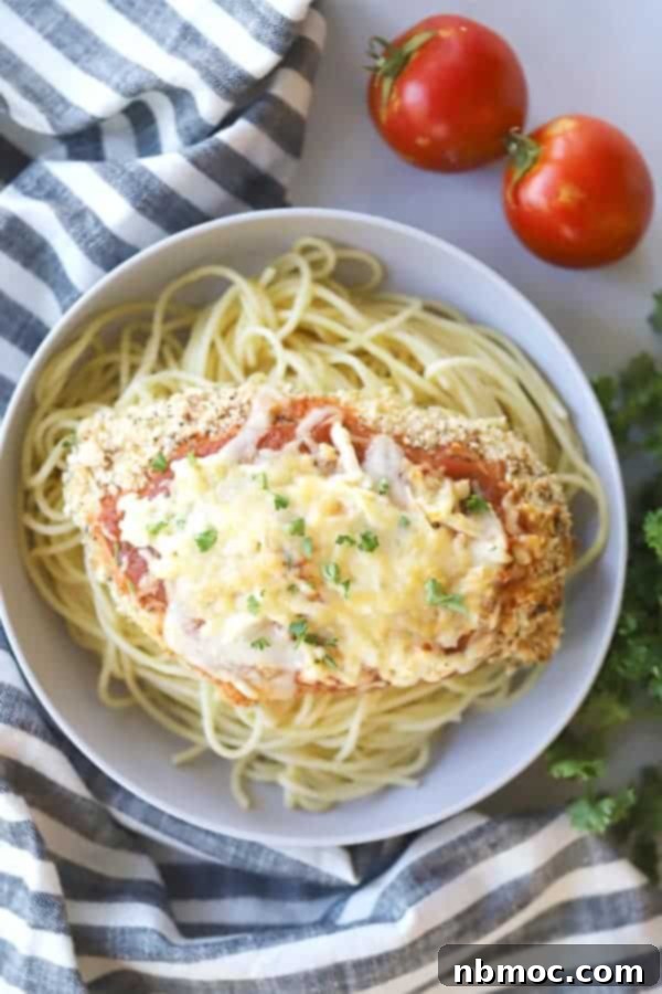 chicken parmesan in a bowl with noodles; chicken milanese.