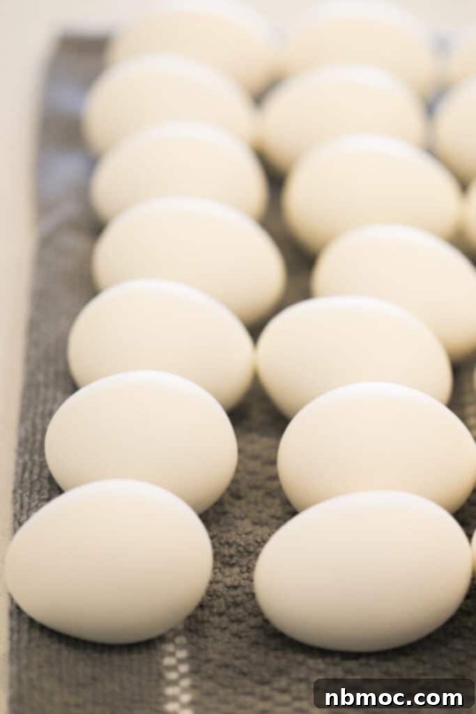 Crafting Colorful Easter Eggs 5 Hard-boiled eggs neatly arranged on a cloth, ready for the Easter egg dyeing process using food coloring.