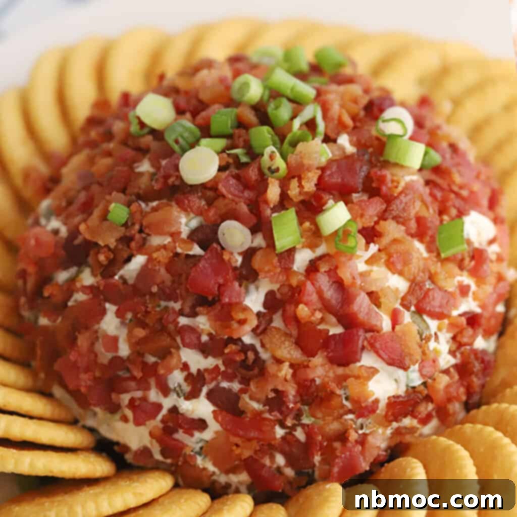 Kickin' Jalapeño Cheese Ball 3 A vibrant jalapeno bacon cheddar cheese ball adorned with fresh scallions and crispy bacon bits, surrounded by a generous spread of Ritz Crackers, making for an inviting appetizer display.