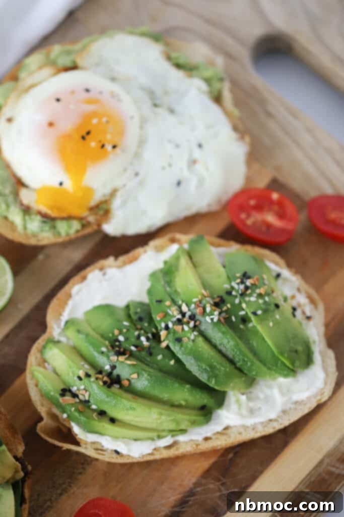 Smashed Green Delight 2 A cutting board with toast topped with sliced avocados and seasoning; Easy Avocado toast recipe, avocado toast seasoning, simple avocado toast with egg.