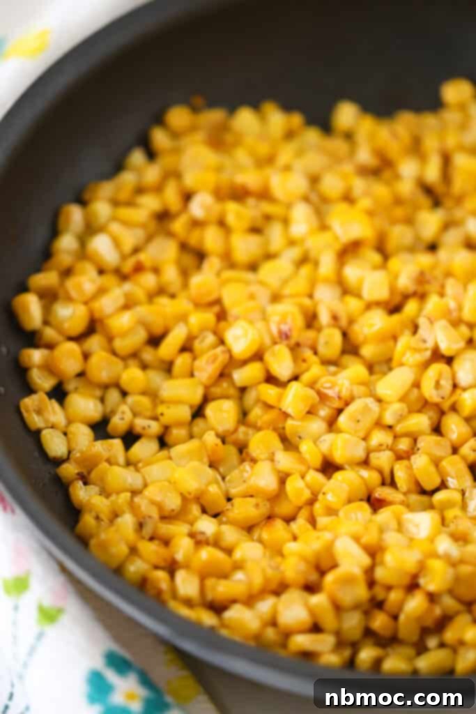 A saute pan with corn kernels for making this easy mexican street corn recipe.