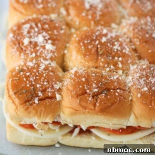 Delicious Pizza Sliders, perfectly baked with melted cheese and pepperoni on top of Hawaiian rolls.