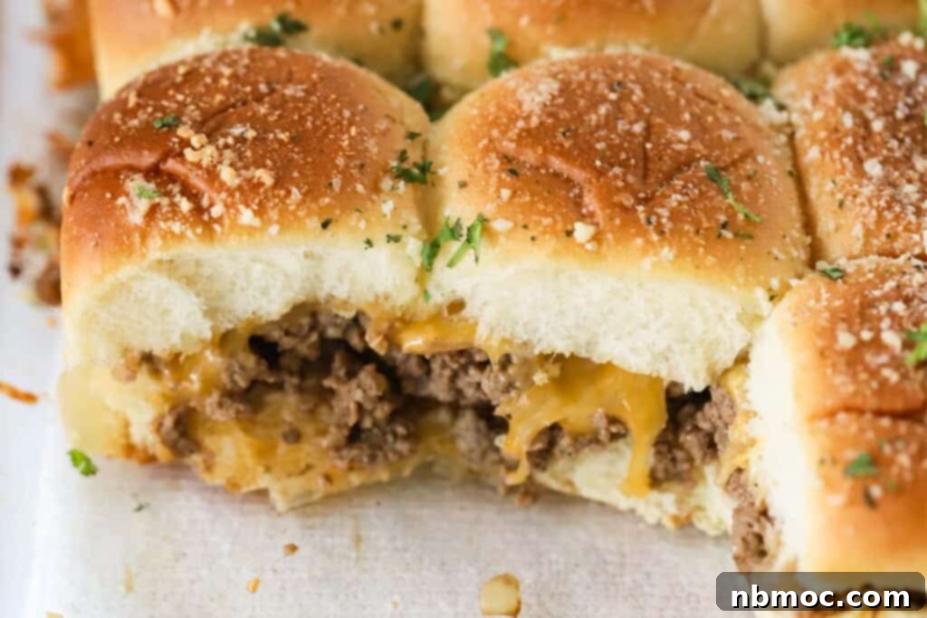 Hawaiian roll hamburger sliders with cheese arranged on a serving tray, ready for a gathering.