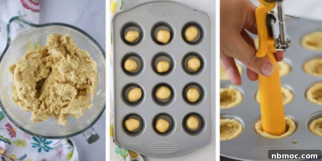 Mini muffin pan filled with unbaked sugar cookie dough, pressed to create cups, ready for baking. This illustrates the process of making lemon cookie cups.