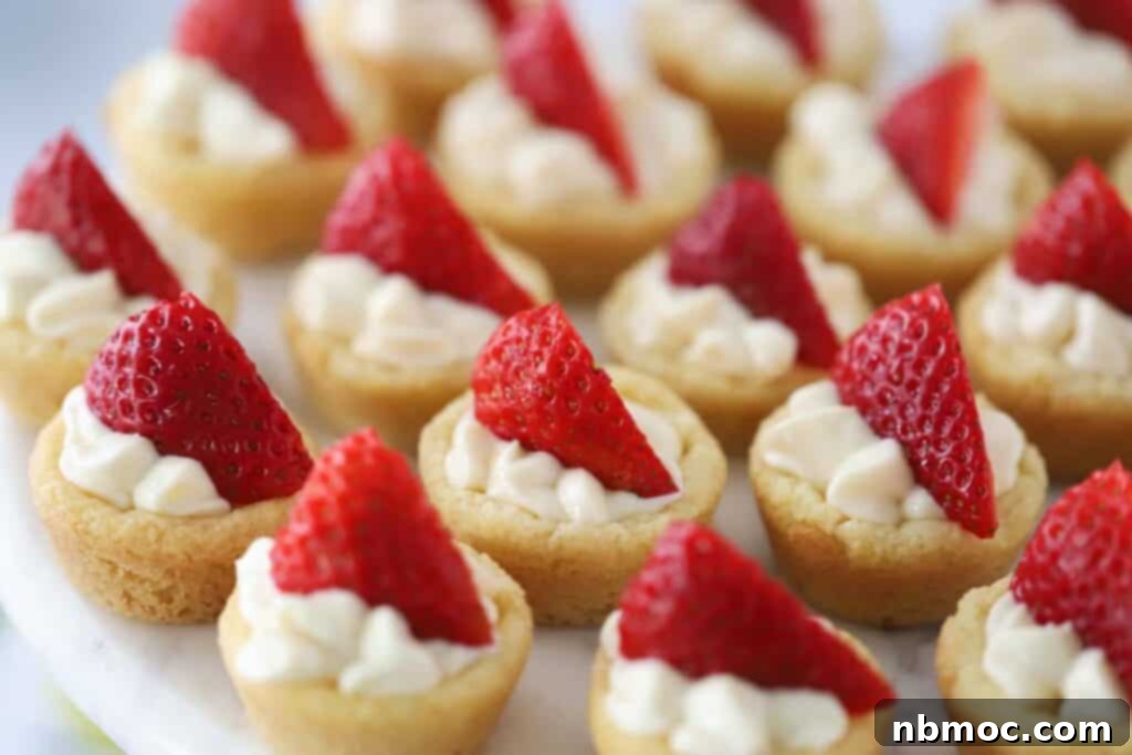 Mini sugar cookie cups filled with lemon cheesecake filling and topped with fresh berries.