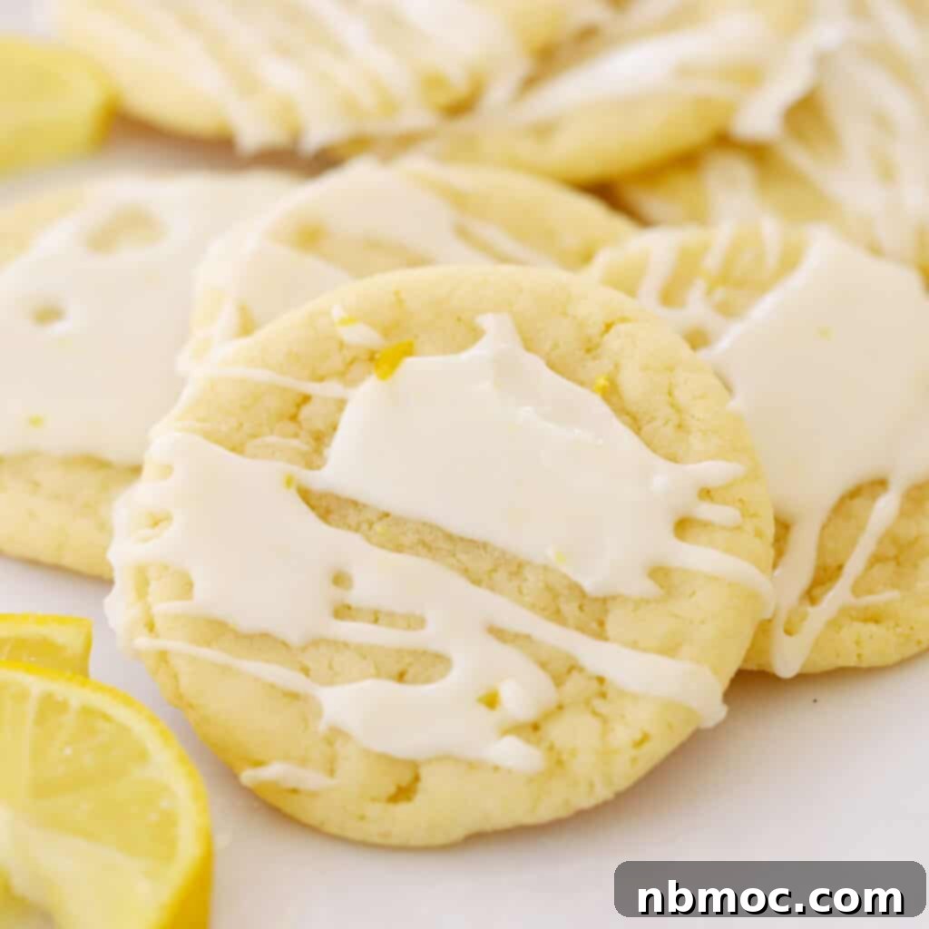 Zesty Lemon Treats 3 glazed lemon cookies on parchment paper, lemon glazed cookies.