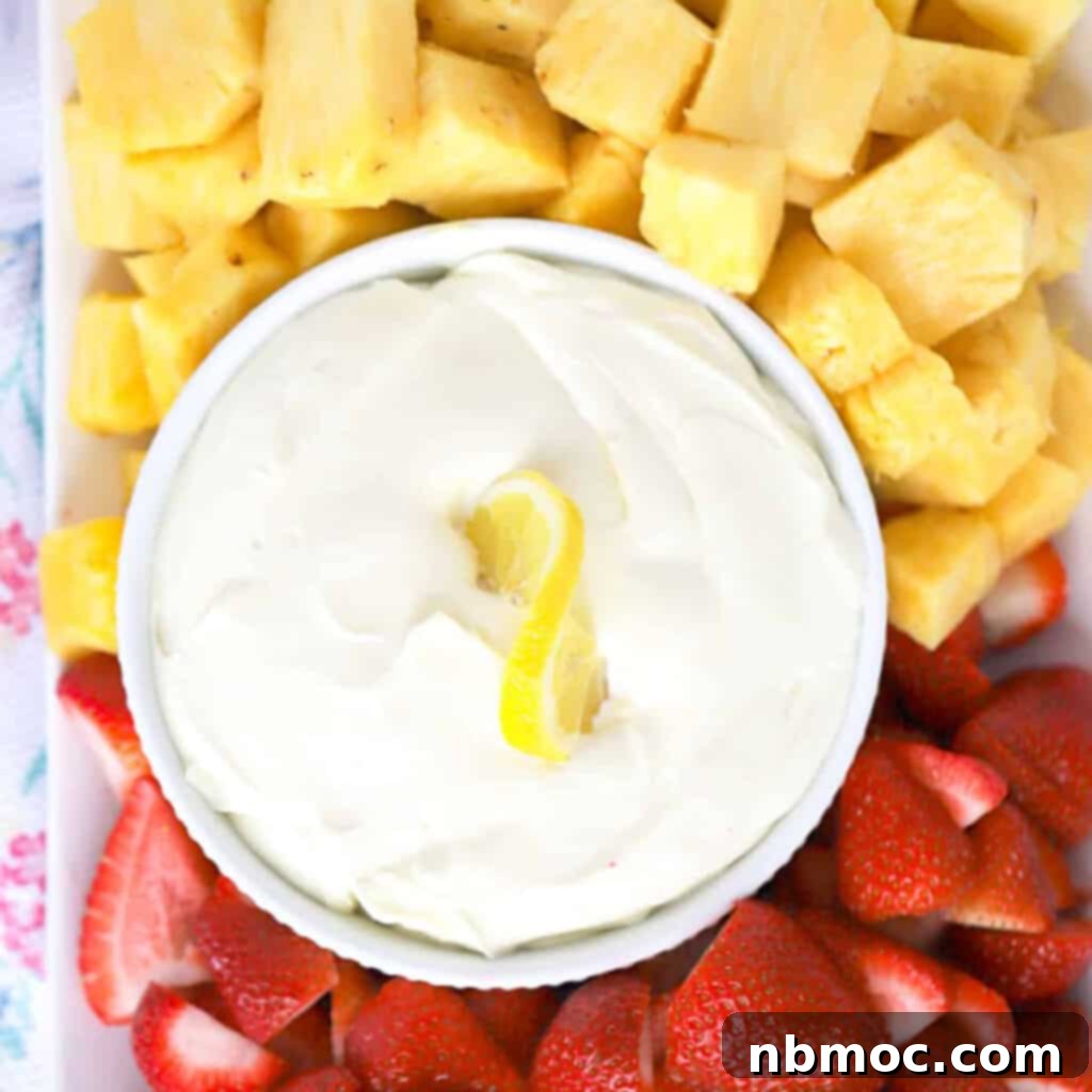 Zesty Lemon Treats 28 lemon Cheesecake Fruit dip on a platter with fresh strawberries and pineapple, best dip for fruit.fruit dip cream cheese.
