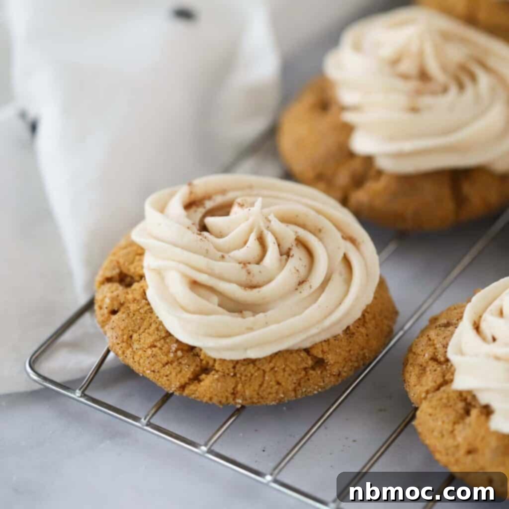 Irresistible Pumpkin Delights 10 pumpkin cookies with cream cheese frosting on a wire rack.