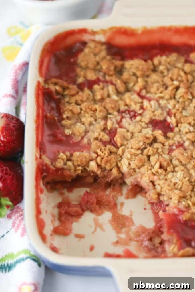 Sweet and Tangy Strawberry Rhubarb Crisp 3 A baking dish with rhubarb strawberry crisp topped with oatmeal crumble.