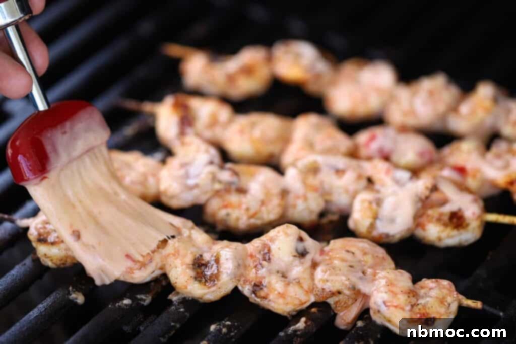 Grilled Bang Bang Shrimp Kabobs 5 Perfectly grilled shrimp kabobs, glistening with Bang Bang sauce, ready to be served.