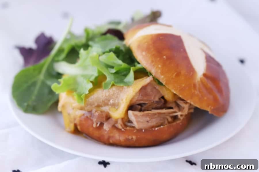 Pork Roast shredded on a pretzel bun, easy crockpot pork roast recipe. 