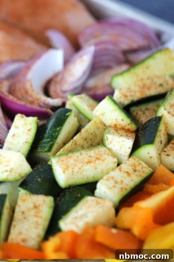 Zesty Chili Lime Sheet Pan Chicken and Veggies 3 vegetables on sheet pan with chili lime seasoning.