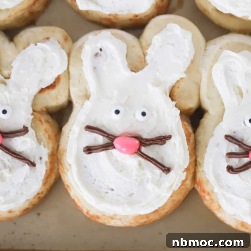 Adorable bunny cinnamon rolls arranged on a baking sheet, perfect for an Easter breakfast treat.