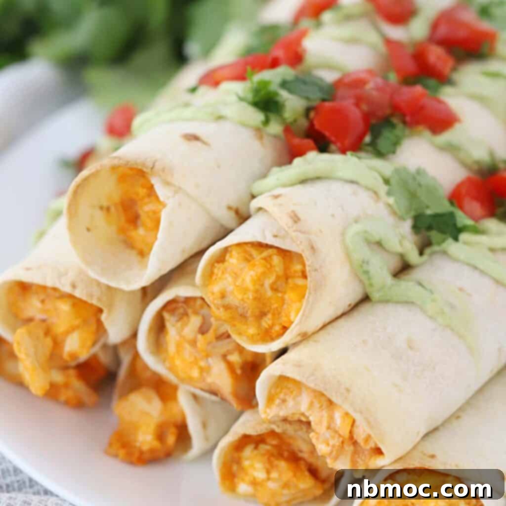 Ultimate Buffalo Chicken Dishes 8 A stack of the best baked buffalo chicken taquitos recipe, perfectly arranged on a plate.