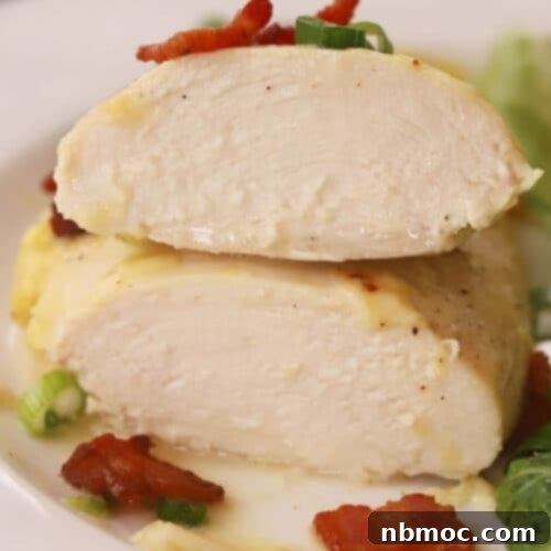 Baked honey mustard chicken, sliced in half to show its juicy interior.