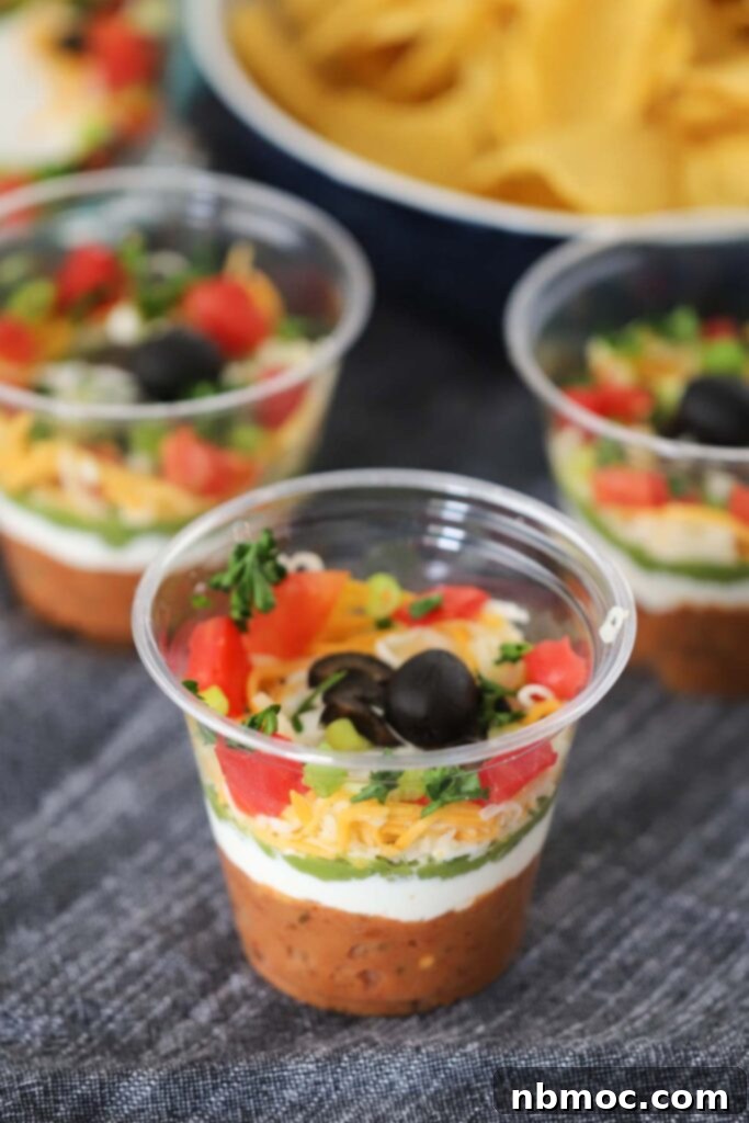 Small cups full of individual portions of homemade bean dip.