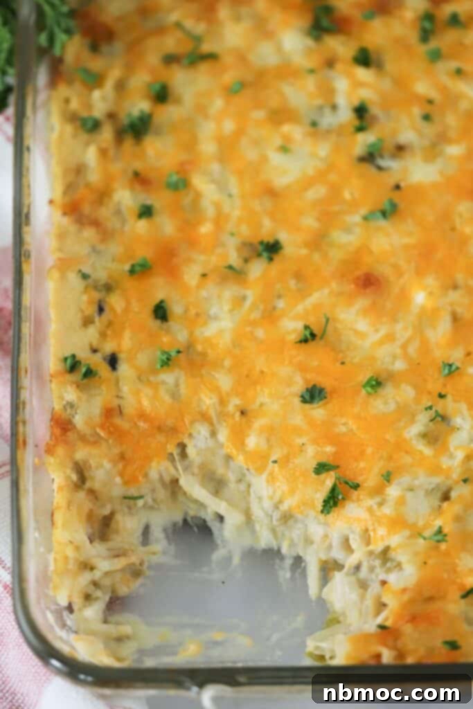 spicy cheesy potatoes, green chile potato casserole, cheesy potato bake. A delectable close-up of a bubbling cheesy potato casserole with green chiles.