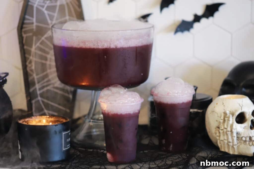 Amethyst Elixir 3 Halloween punch for kids in a large punch bowl with serving glasses, ready for a party.