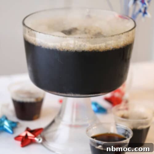 Crafting Your Own Root Beer 5 A punch bowl filled with homemade root beer, gently fizzing with dry ice, creating a misty effect for an easy Halloween party idea.