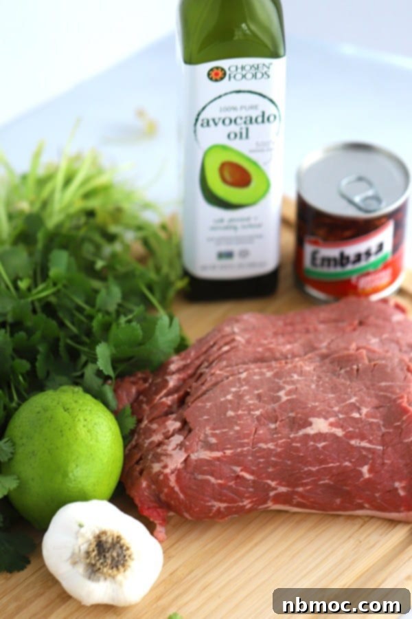 Chipotle Carne Asada Marinade recipe ingredients: carne asada steak, avocado oil, garlic, cilantro, lime, chipotle peppers in adobo, and carne asada seasoning.