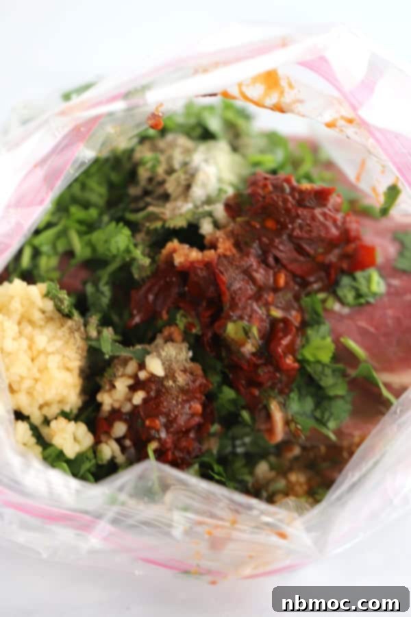 How to prepare Carne Asada Marinade in a ziplock bag for chipotle-flavored steak, showcasing the marinade ingredients ready for the meat.