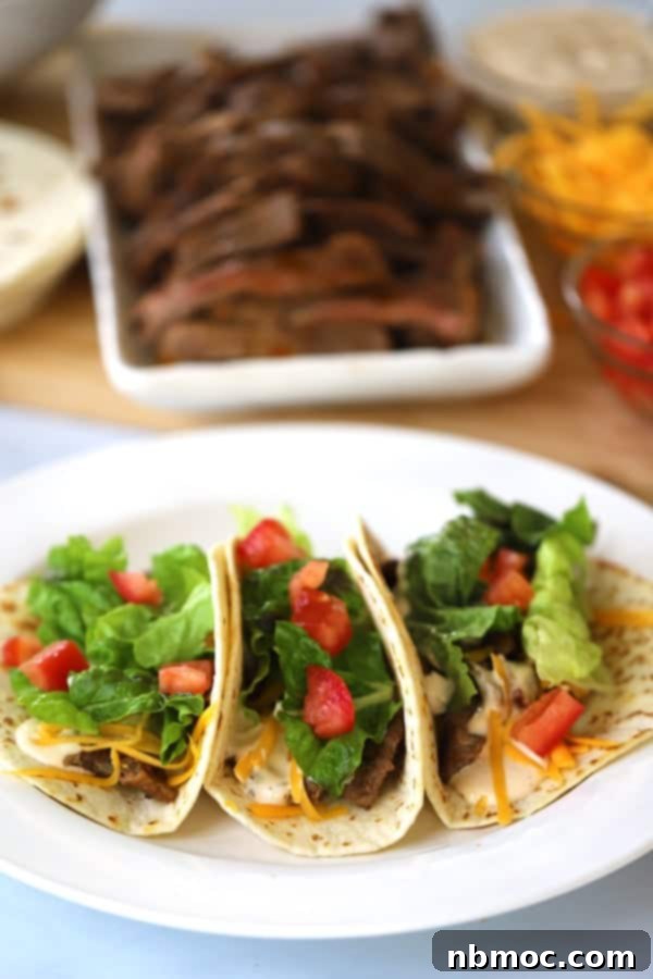 Chipotle Carne Asada served on a platter with sliced steak and taco fixings, perfect for burritos and tacos.