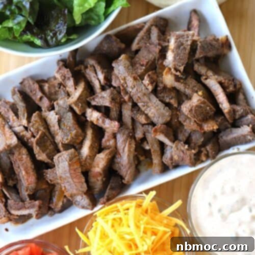 Chipotle Carne Asada on a platter with taco fixings