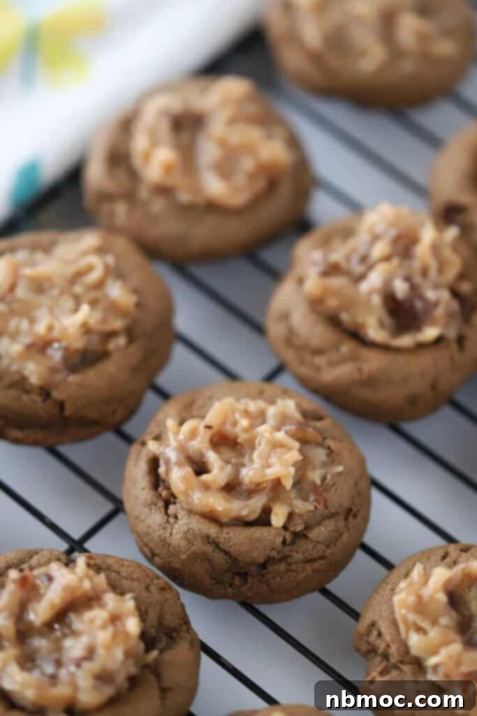 A wire cooling rack with german chocolate cookies cooling, chocolate german cookies.
