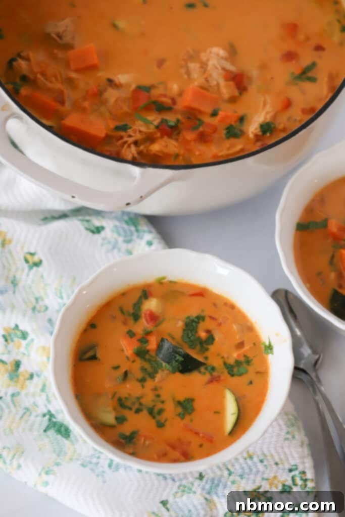 Thai Coconut Chicken Curry Soup 4 A large dutch oven full of chicken curry thai soup with a serving bowl. This easy coconut curry thai chicken soup is loaded with veggies and curry flavor.