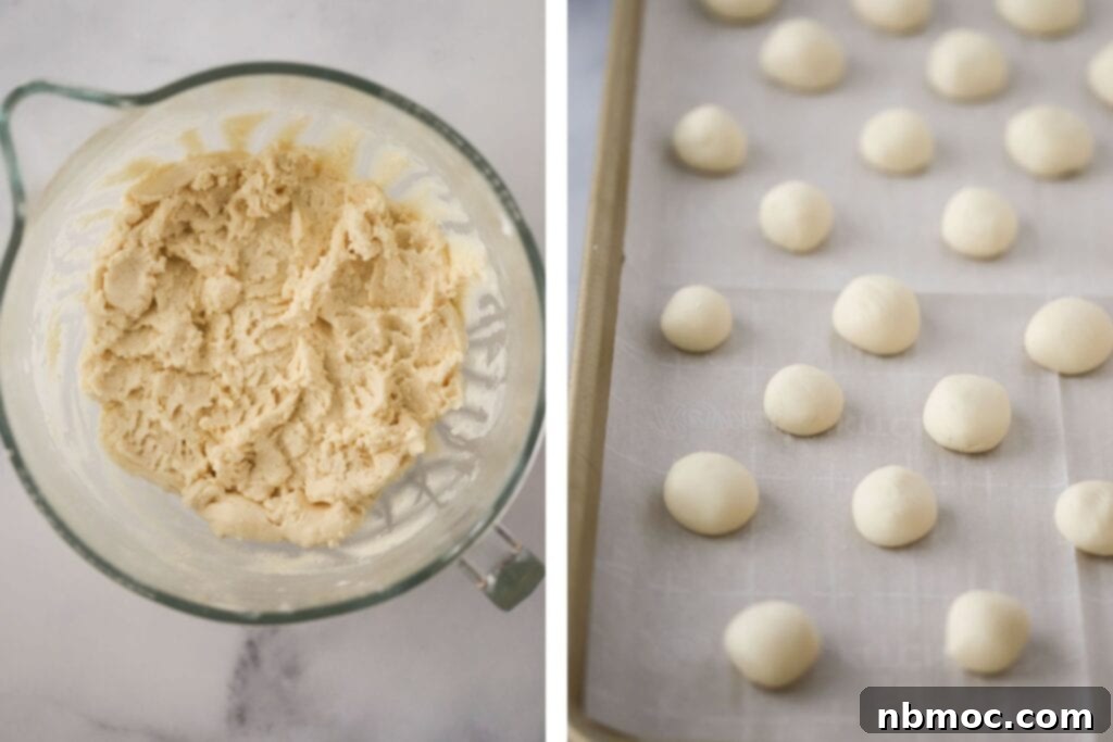 A bowl of creamy peppermint patty filling alongside a baking sheet with pre-rolled peppermint dough balls, ready for shaping.