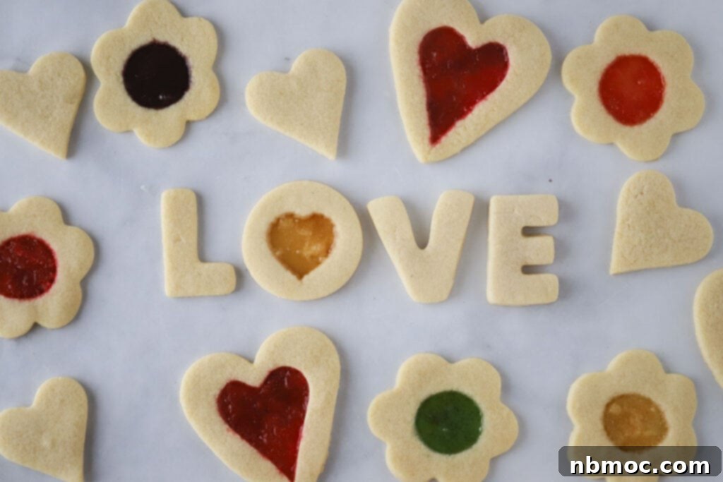 Jewel Window Cookies 4 Close-up of Stained Glass Window Cookies with heart and flower shaped cookie cutters, featuring vibrant and colorful melted hard candies in their centers.