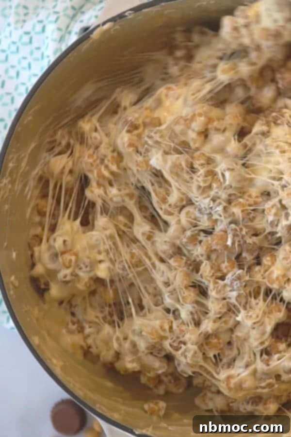 Mixing Reese's No Bake Bars in a pot, showcasing the gooey peanut butter and marshmallow mixture.