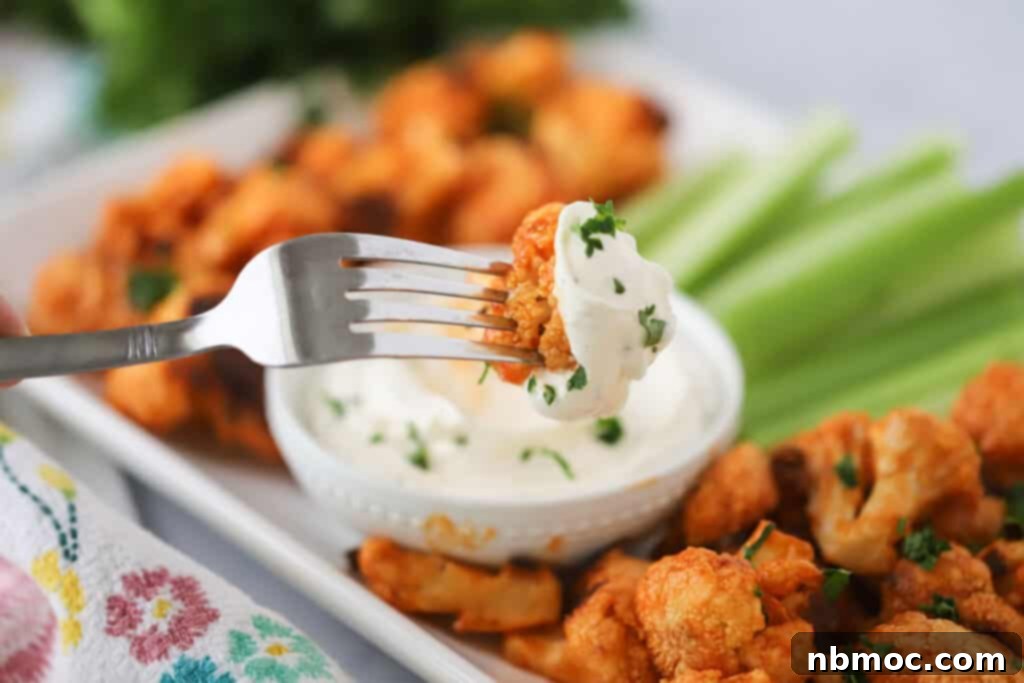 Zesty Ranch Dip 3 Hidden Valley Ranch dip in a small bowl served with buffalo cauliflower and celery sticks for dipping.