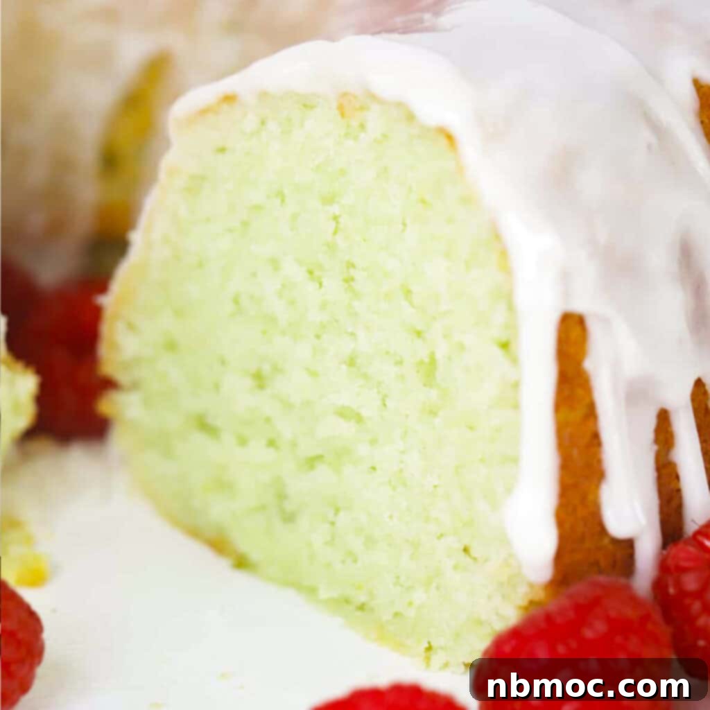 Zesty lime bundt cake served with a fresh lime glaze and berries, a refreshing dessert.