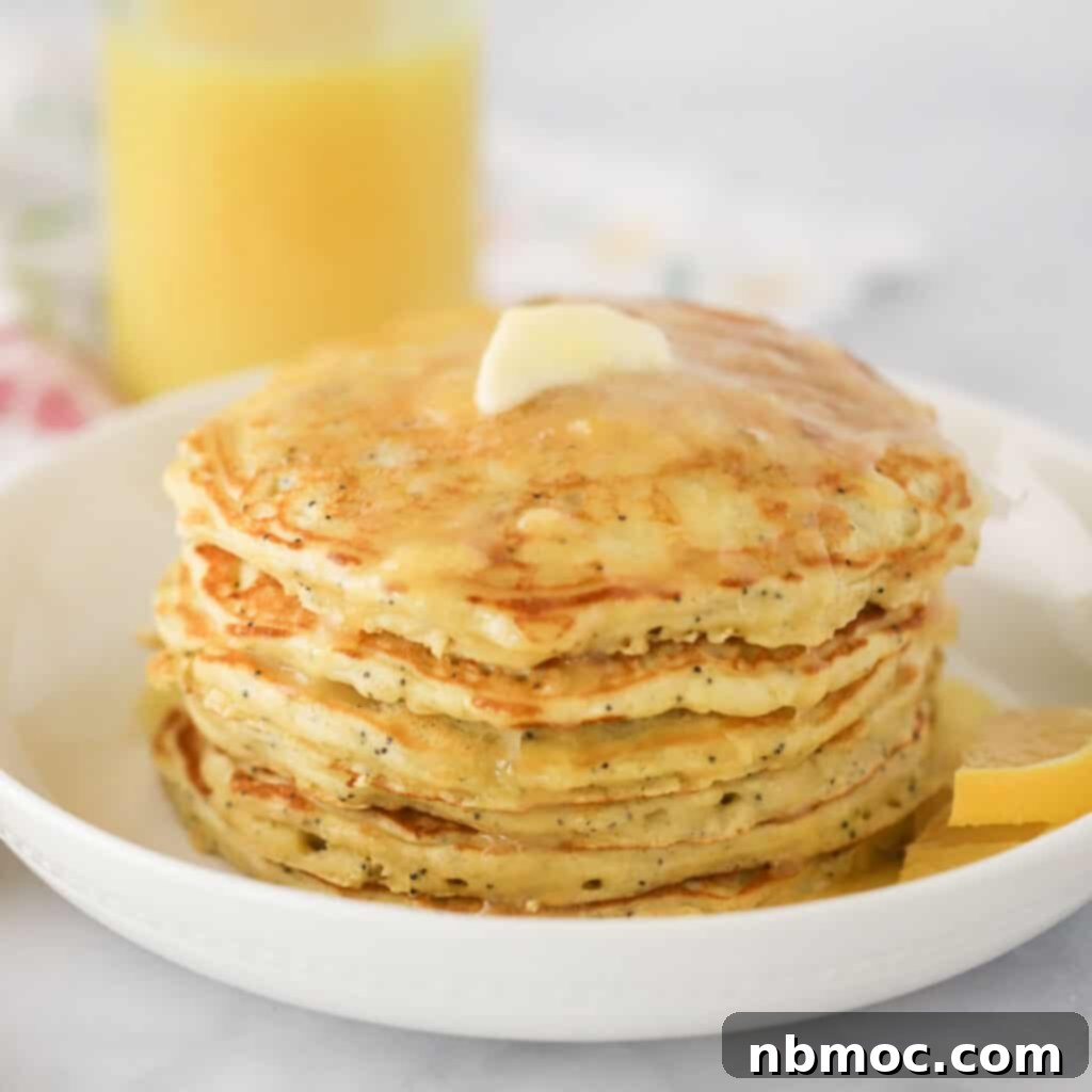 Sunny Lemon Poppy Seed Pancakes 4 A stack of golden lemon poppy seed pancakes, ready to be enjoyed with melted butter and syrup, showcasing an easy and delicious breakfast recipe.