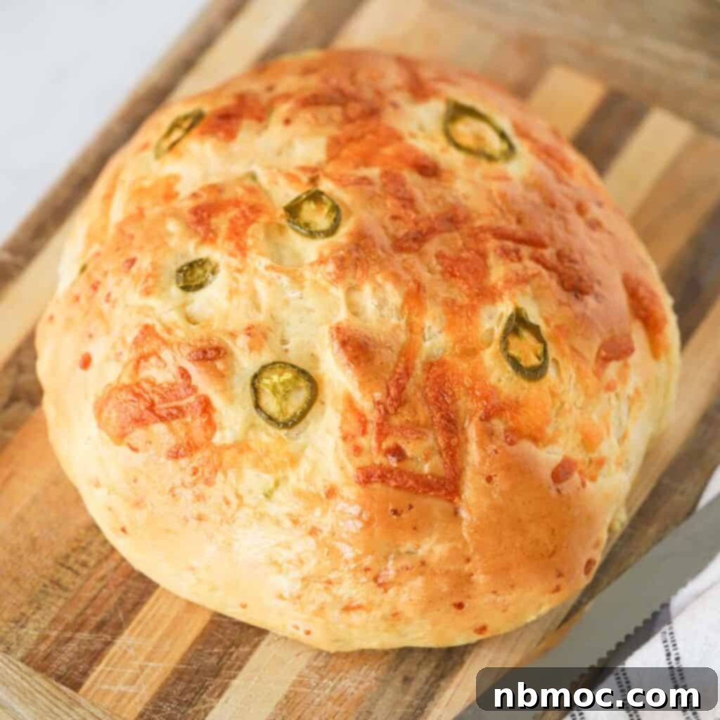 Mastering the Art of Yeast Bread 7 A round loaf of cheddar jalapeno bread on a cutting board.