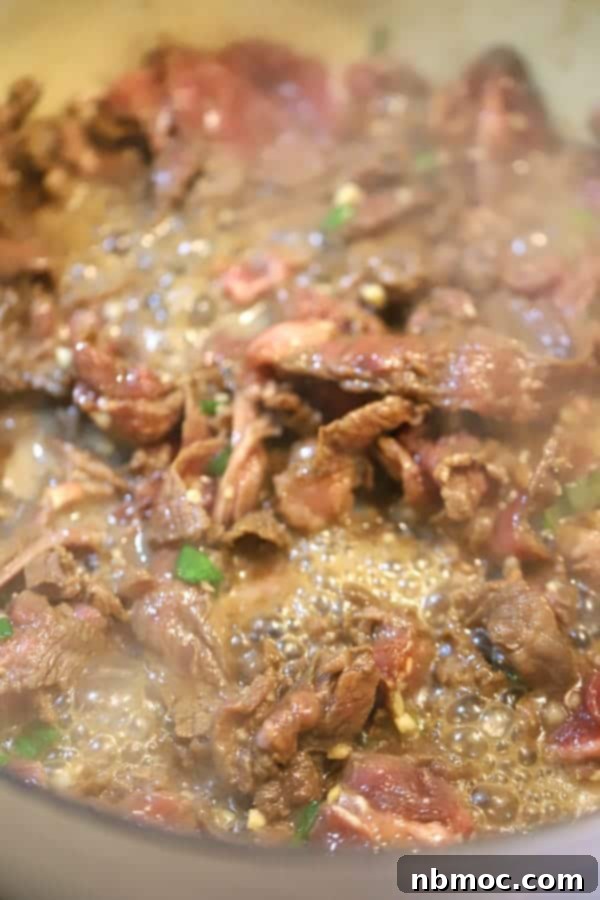 Sticky Teriyaki Beef and Vegetable Skillet 4 carne picada in a skillet, cooking for teriyaki stir fry.