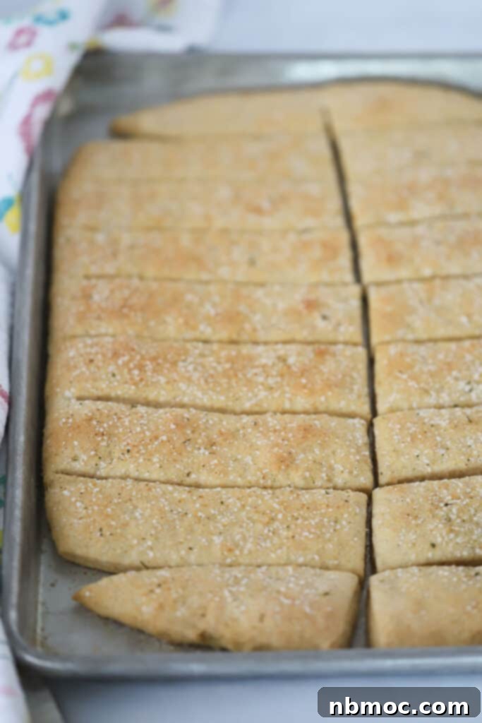 Golden Grain Breadsticks 4 A pan of this whole wheat breadstick recipe on a baking sheet cut into rectangles.