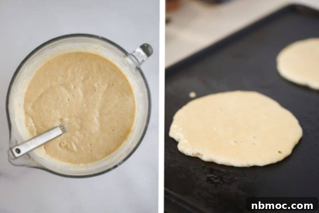 A close-up view of whole wheat pancake batter sizzling on a hot griddle, showing the cooking process.