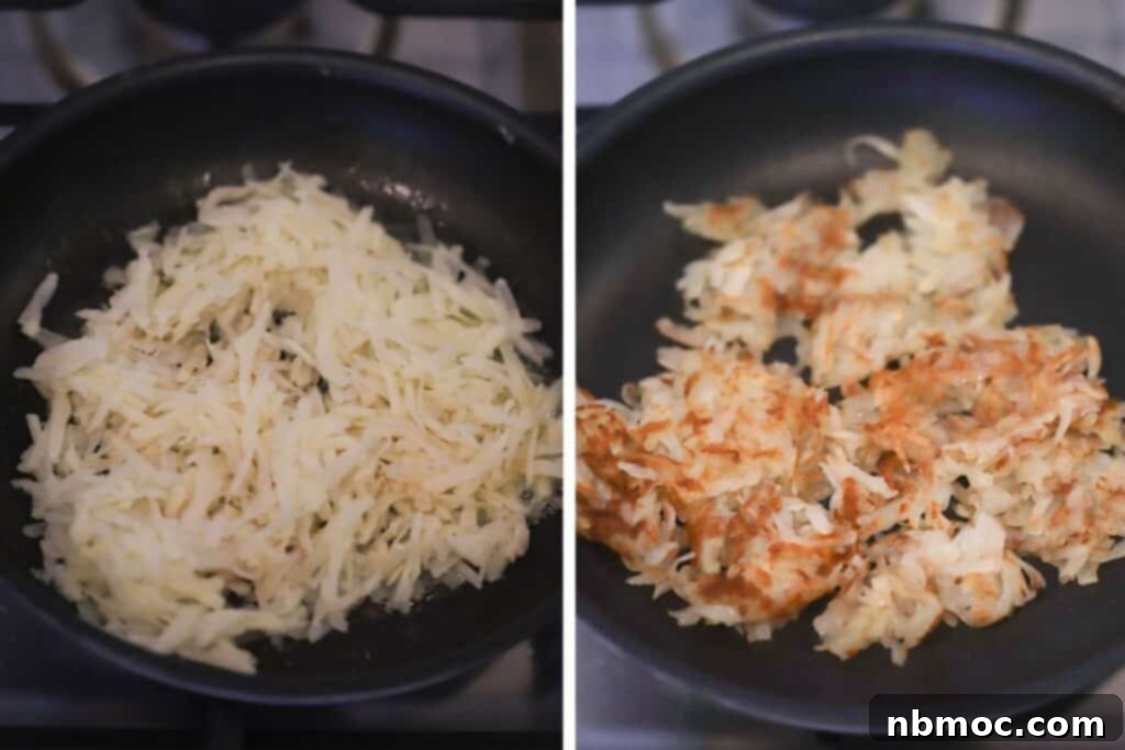 A nonstick skillet with shredded potatoes, cooking until golden brown for breakfast tacos.