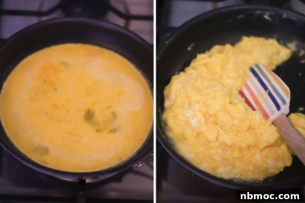 Scrambled eggs cooking in a nonstick skillet with a silicone spatula gently folding.