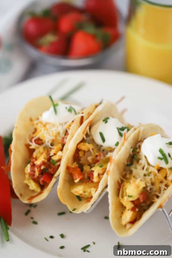 Southwest Breakfast Tacos with chorizo, eggs, potatoes, and sour cream in a taco holder. A complete and hearty breakfast.