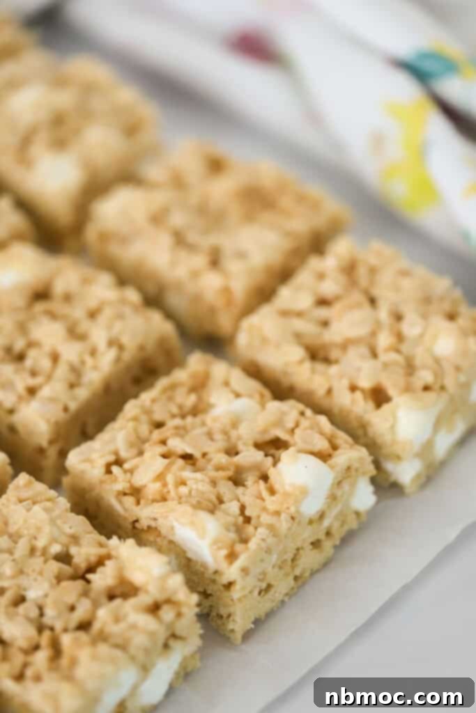 Rows of caramel rice krispie treats lined up on a serving plate, ready to be enjoyed.
