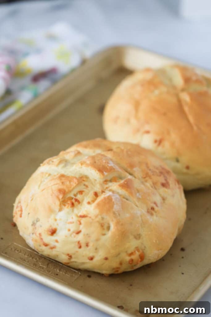 Aromatic Rosemary Bake 4 A baking sheet with two freshly baked loaves of rosemary garlic bread.