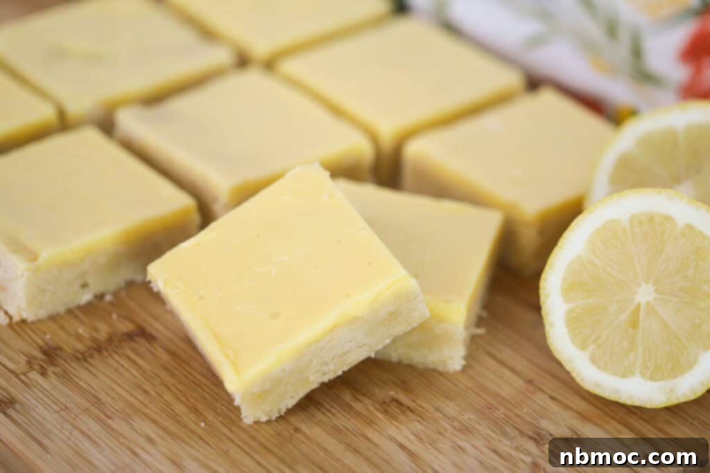Individual lemon blondie squares beautifully arranged on a rustic wooden cutting board, ready to be enjoyed.