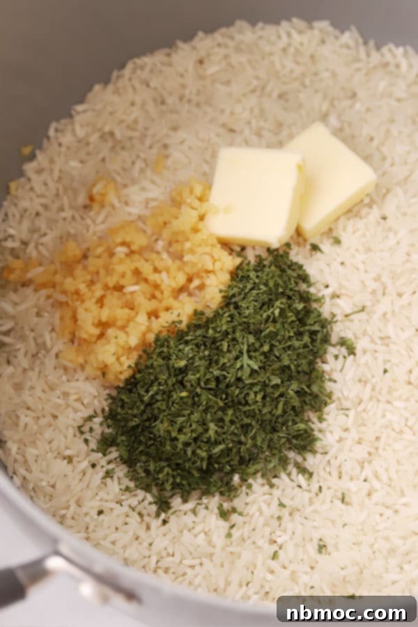 Buttery Garlic Parmesan Rice 3 raw ingredients for garlic parmesan rice in a pot.