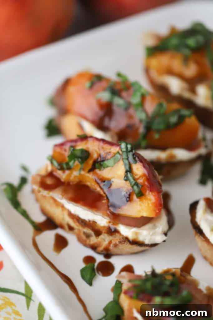 Grilled Peach Crostini made with honey cream cheese and topped with balsamic glaze and fresh basil.