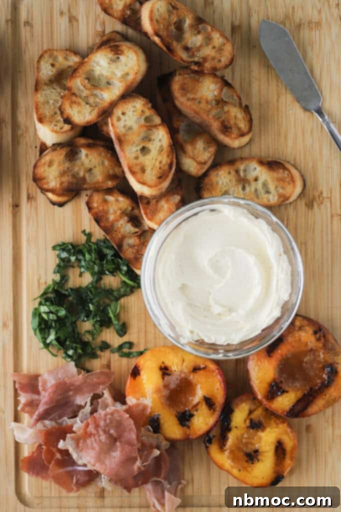 A cutting board with grilled baguettes, whipped honey cream cheese, grilled peach slices, pancetta, and sliced basil for making peach bruschetta.